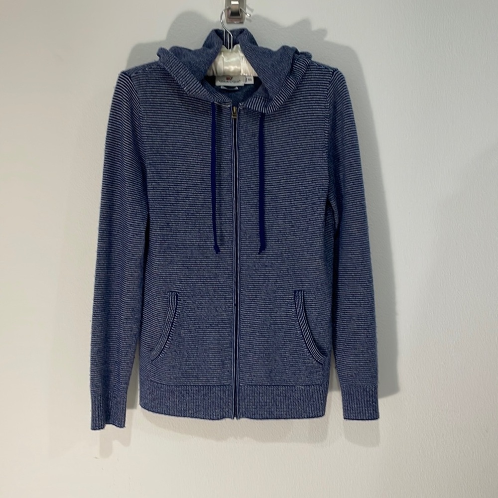 Sweater with hood, zip up, has pockets.